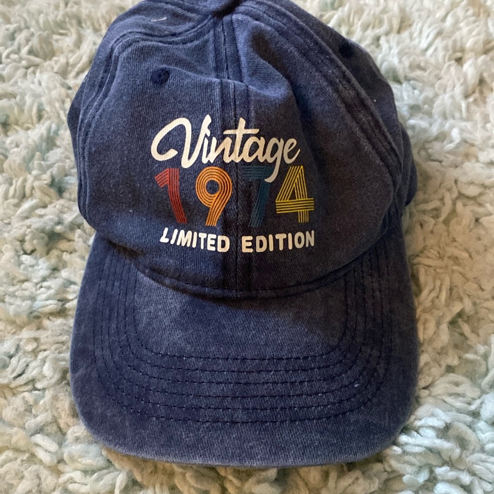 “Vintage 1974” adult hat. Never worn. Blue Adjustable in the back.